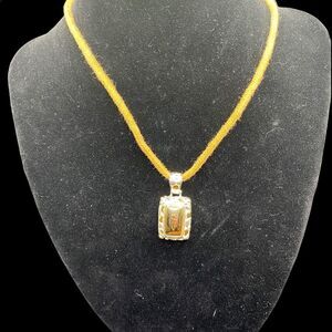 Rectangle gold and silver tone pendant with leopard spots brown adjustable cord